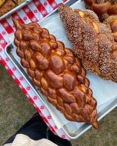 there are many different types of breads on the tray together, including pretzels