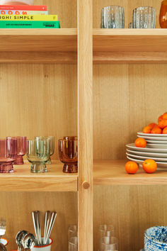 the shelves are filled with dishes and glasses