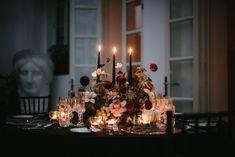 a table with candles and flowers on it