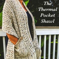 a woman standing on a porch wearing a cardigan