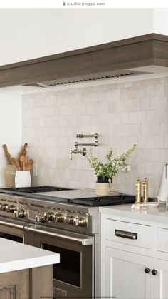 a kitchen with an oven, stove and counter tops in it's center island