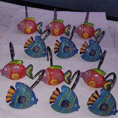 several colorful fish shaped hooks are on display