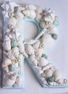 the letter p is made up of seashells and pearls