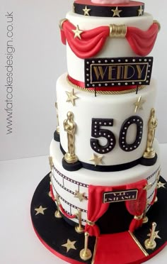 a three tiered cake with the number 50 on it