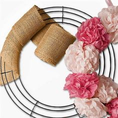 a wreath with burlap and pink flowers on it