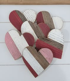 heart shaped wooden cutouts are arranged on a white surface with wood planks in the shape of hearts