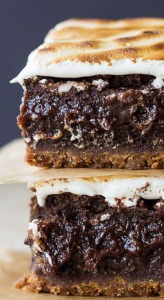 two pieces of cake sitting on top of a wooden cutting board next to each other