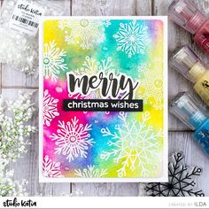 a christmas card with watercolor snowflakes on it and some crayon markers