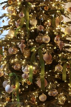 a decorated christmas tree with gold and white ornaments