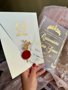 a woman holding two wedding cards in her hand and a wax stamp on the front