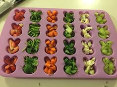 a tray filled with cut up vegetables on top of a table