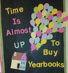 a bulletin board with balloons and a house