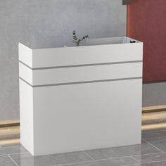 a white reception table sitting on top of a tiled floor next to a red wall