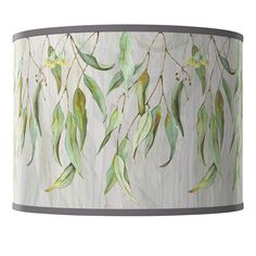 a lamp shade with green leaves painted on it