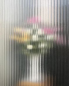 a vase with flowers sitting on top of a window sill