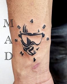 a man's arm with a tattoo on it that has an image of a helmet and arrows