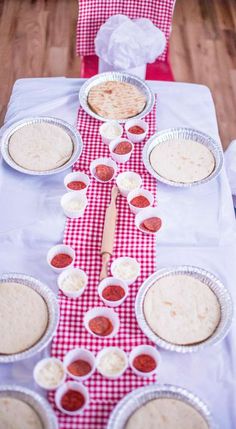 the table is set up with many different foods on it, including pita breads