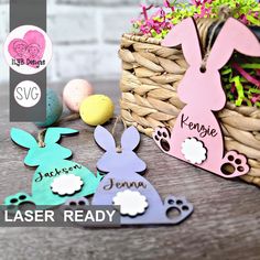 easter decorations with bunny ears and personalized name tags in front of a basket filled with eggs