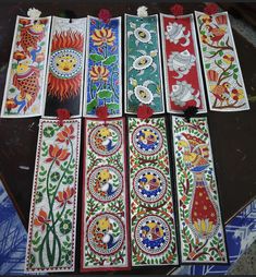 seven colorfully painted cards laid out on a table