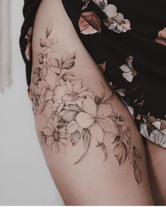 a woman's thigh with flowers on it