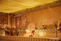 an elaborately decorated room with gold and white decor on the walls, along with other decorative items