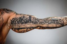 a man's arm with tattoos on it and an image of the last supper