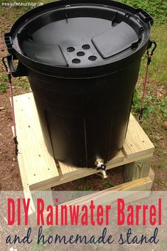 a black barrel sitting on top of a wooden pallet with the words diy rainwater barrel and homemade stand