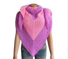 a crocheted pink and purple shawl on top of a mannequin