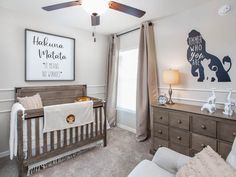 a baby's room with a crib and dresser