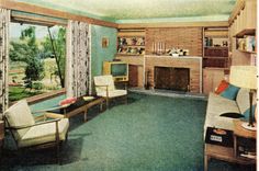 an old fashioned living room with green carpet and wood paneled walls, painted in blue