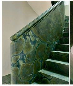 there is a green marble stair case next to a white toilet in the same room