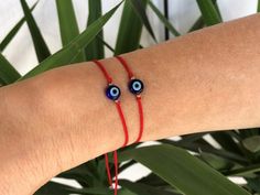 Red string blue evil eye bracelet - good luck bracelet - gift for him or for her Great gift for a maximum protection or just for an ethnic style. This bracelet can be worn as well by a child, a woman or a man. Composed of a white glass eye in the center, and decorated with small silver or gold stainless steel beads. Materials : ★ 8mm dark blue evil eye bead flat and round ★ 0.5mm double nylon red cord (strong) ★ Stainless steel beads in silver or gold plated ★ Adjustable slip knot, you just have Blue Bracelets For Festivals As A Gift, Blue Bracelets For Festivals And Gifts, Blue Bracelets Gift For Festivals, Adjustable Blue Bracelets For Festivals, Blue Festival Bracelets Gift, Blue Evil Eye Bracelet With Sliding Knot As Gift, Blue Evil Eye Bracelet With Sliding Knot For Gift, Bohemian Evil Eye Bracelet With Adjustable Cord As Gift, Handmade Red Evil Eye Bracelet As A Gift