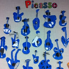 there are many blue guitars on the wall