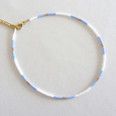 Blue bead choker white beaded choker gold bead choker colorful bead choker seed bead choker boho bead choker summer necklace trendy choker Measure the length of your neck with a measuring tape or you can use any thread, rope, or cable for telephone and after apply the measurements to a regular ruler. These are multi-colored, opaque shiny beads of size 10/0. Choker is 13 inches with a 2 inches adjustable extender chain. 15 inches full length. Summer Choker Necklace, Summer Seed Bead Bracelet Ideas, Seed Beads Necklace Ideas, Gold Round Beads Choker For Summer, Gold Choker With Round Beads For Summer, Summer Spacer Bead Choker Jewelry, Summer Beaded Chain Choker Jewelry, Blue Tiny Beads Choker For Summer, Summer Beaded Chain Choker