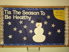 a bulletin board that says tis the season to be healthy with a snowman on it