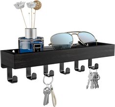 a wooden shelf with sunglasses and keys on it