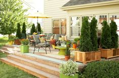 an outdoor patio with potted plants and chairs