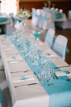 the table is set up with blue and white linens for an elegant wedding reception