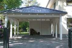 a white gazebo sitting in the middle of a driveway