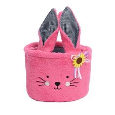 a pink bunny rabbit shaped basket with ears on it's head and eyes painted on the side