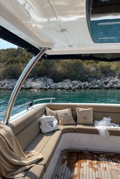 the inside of a boat with pillows on it