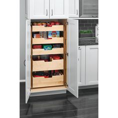 an open pantry door in a kitchen with white cupboards and drawers on the side