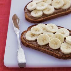 two slices of toast with peanut butter and bananas on them