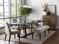 a dining room table with chairs and a bench