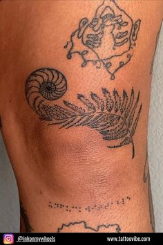 a close up of a person's leg with tattoos on it and an image of a snail