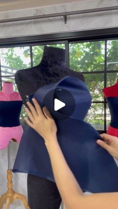 a woman is making a mannequin out of fabric