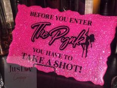 a pink sign that says before you enter the park you have to take a shot