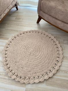 a crocheted rug on the floor in a living room