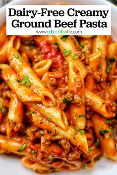 a white bowl filled with pasta covered in meat and sauce, topped with parsley