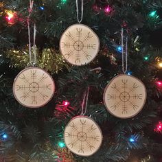 three wooden ornaments hanging from a christmas tree